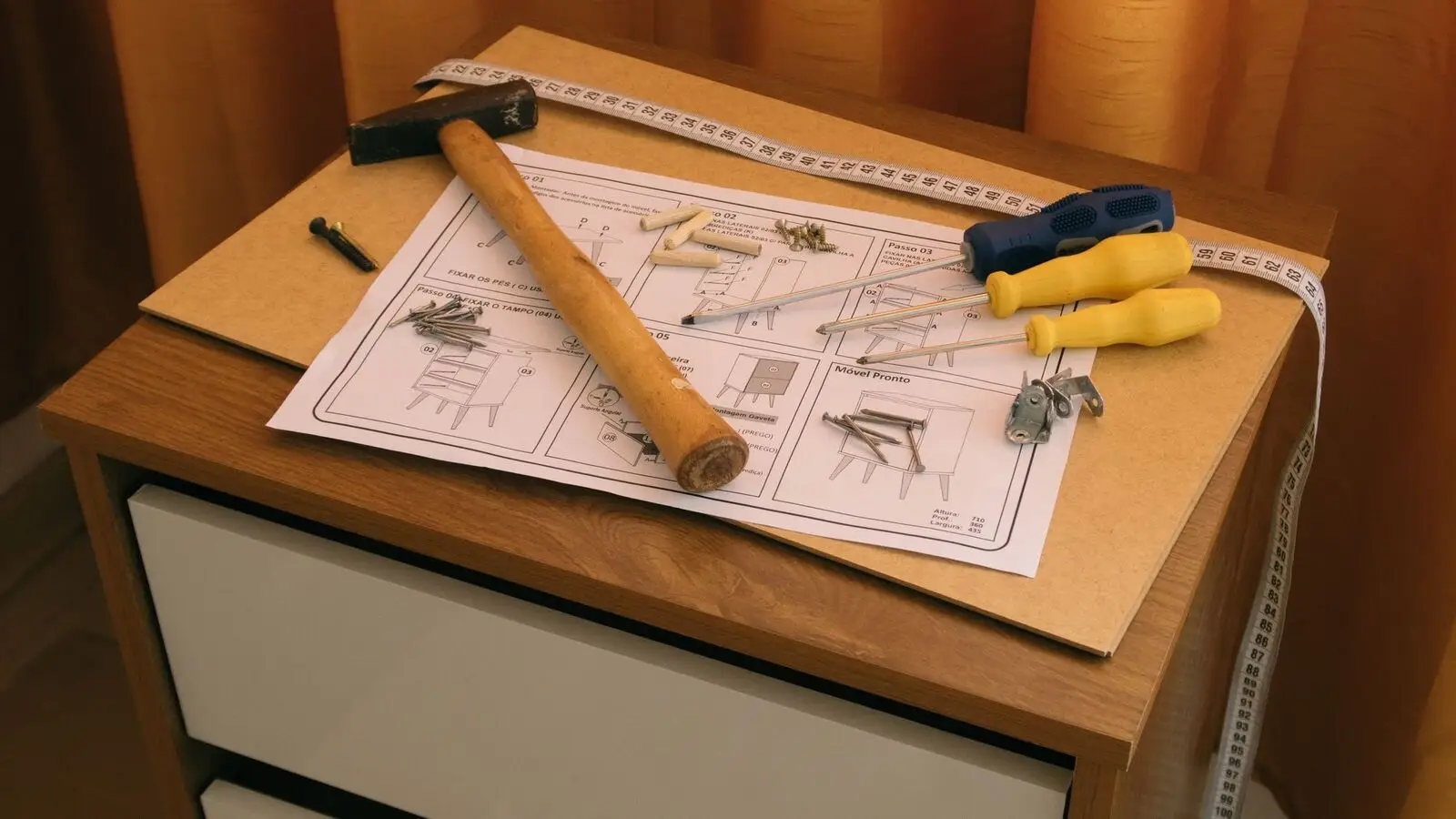 Gym equipment installation tools laid out with paper instructions