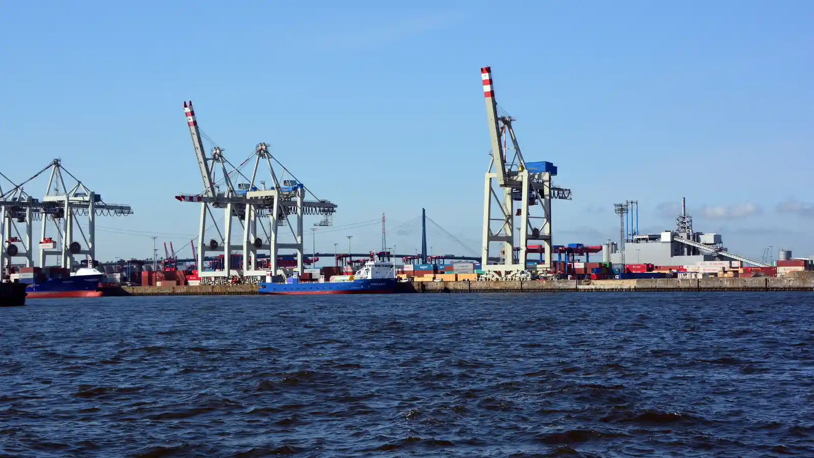 Container terminal with gantry cranes loading a container ship