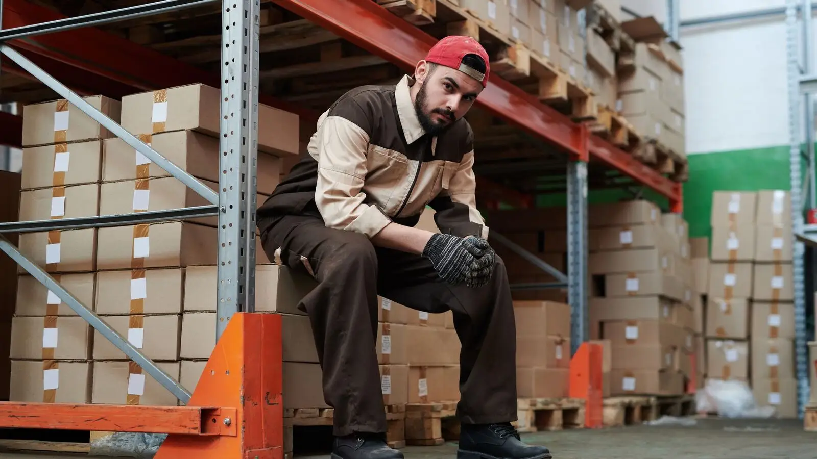 Warehouse worker with cartons stacked for shipment
