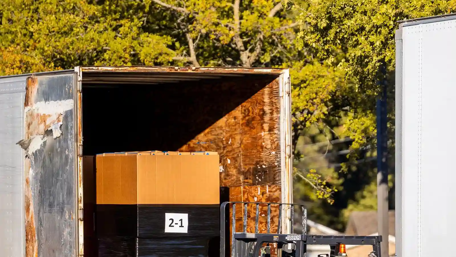 Gym equipment lead time starts at the factory: a forklift loading a pallet onto a delivery truck