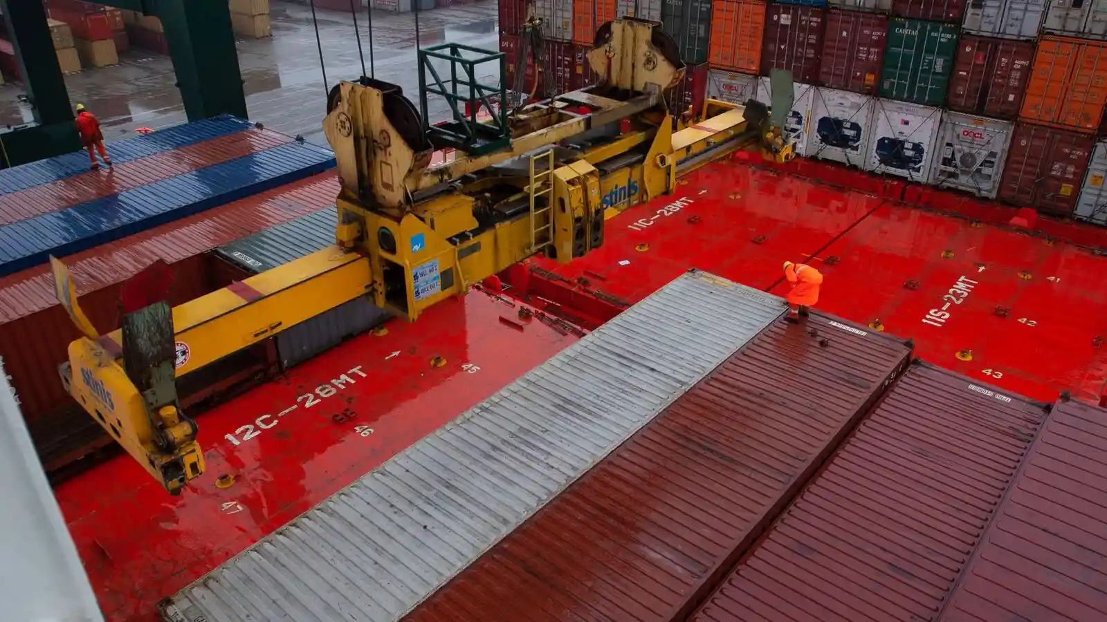 Gantry cranes loading a container ship at a commercial port