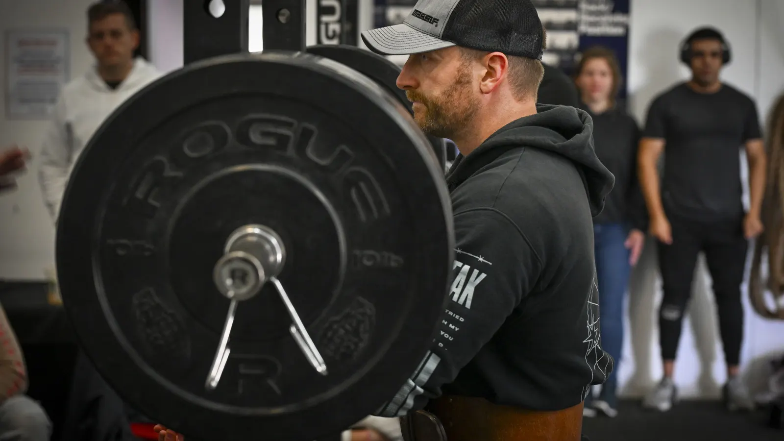 Powerlifting gym equipment in use: a lifter preparing to squat at a competition