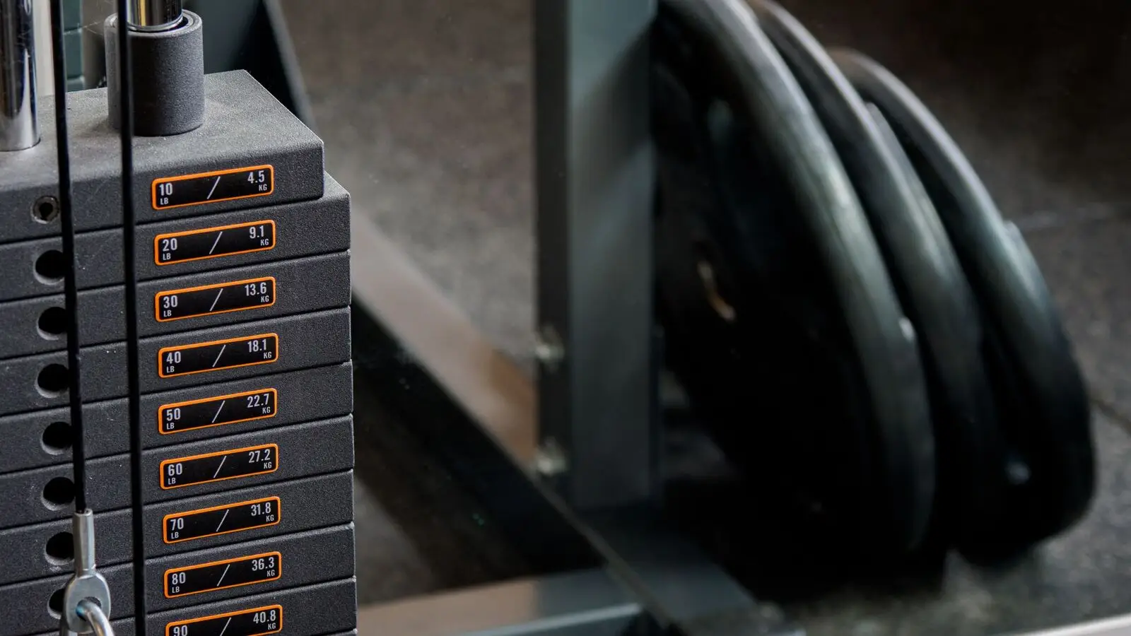 A selectorized strength machine with its weight stack and guide rods visible