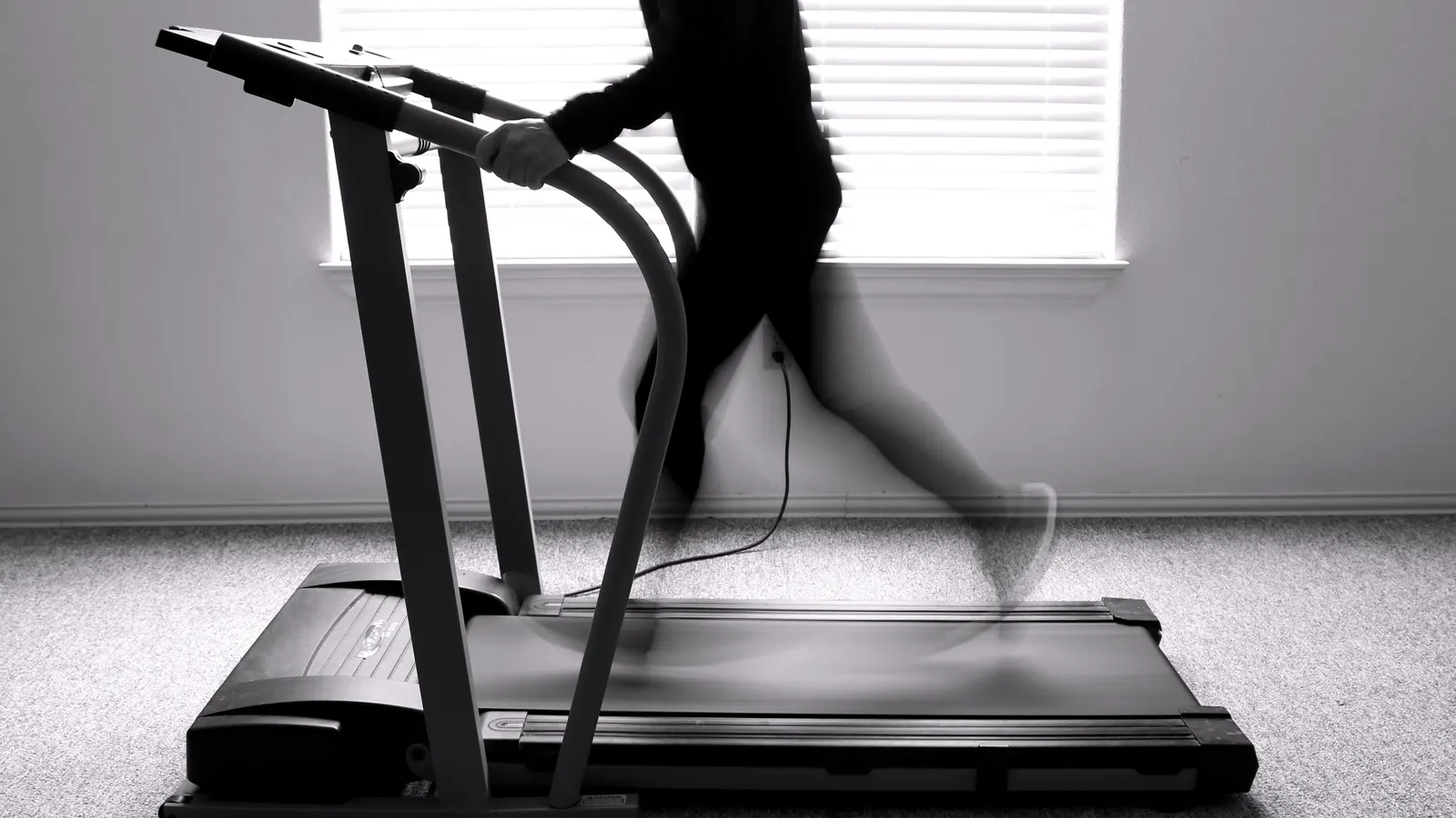 Treadmill running belt moving over the deck