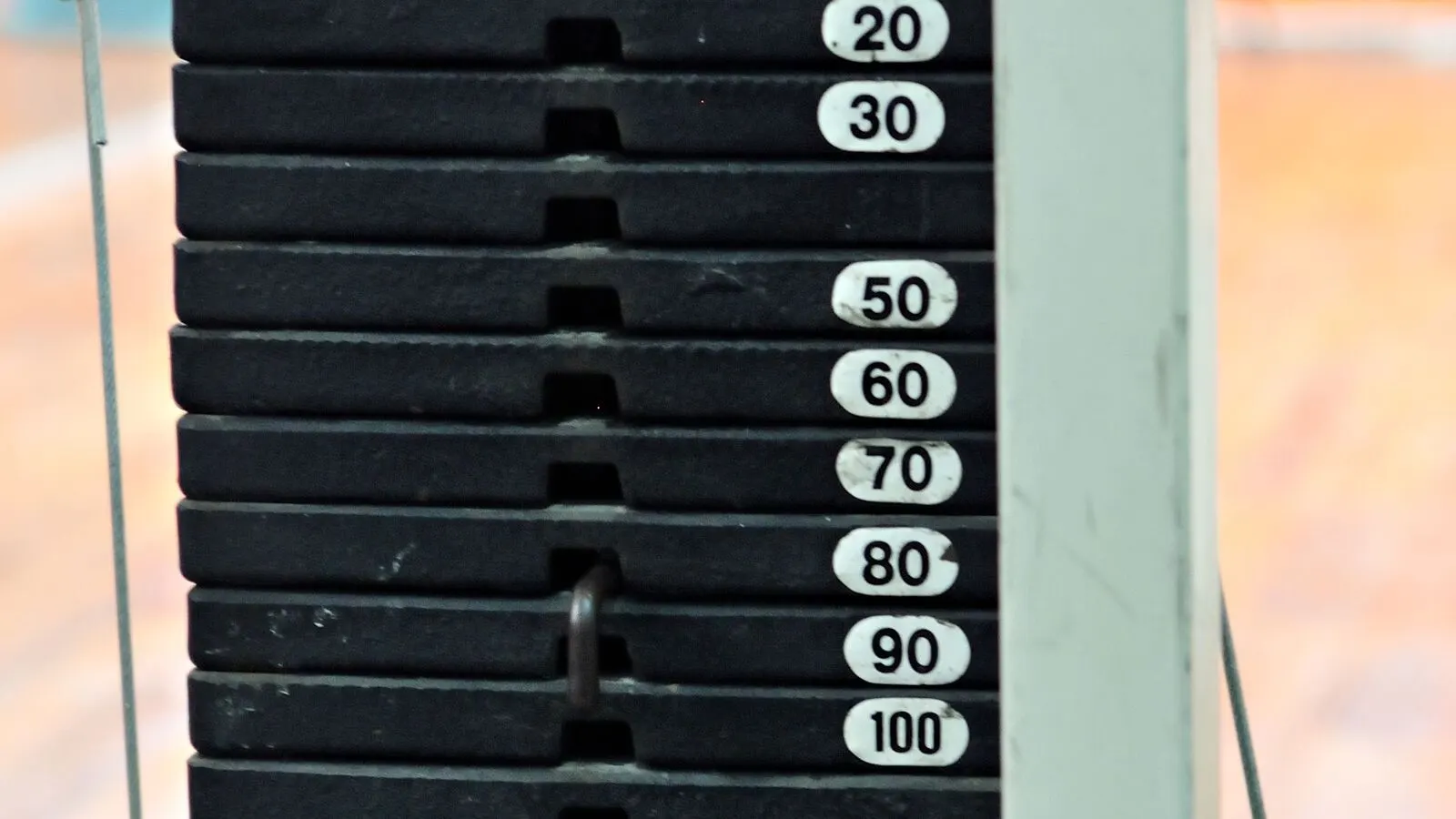 Close-up of gym equipment spare parts in service: a weight stack and selector pin on a commercial strength machine